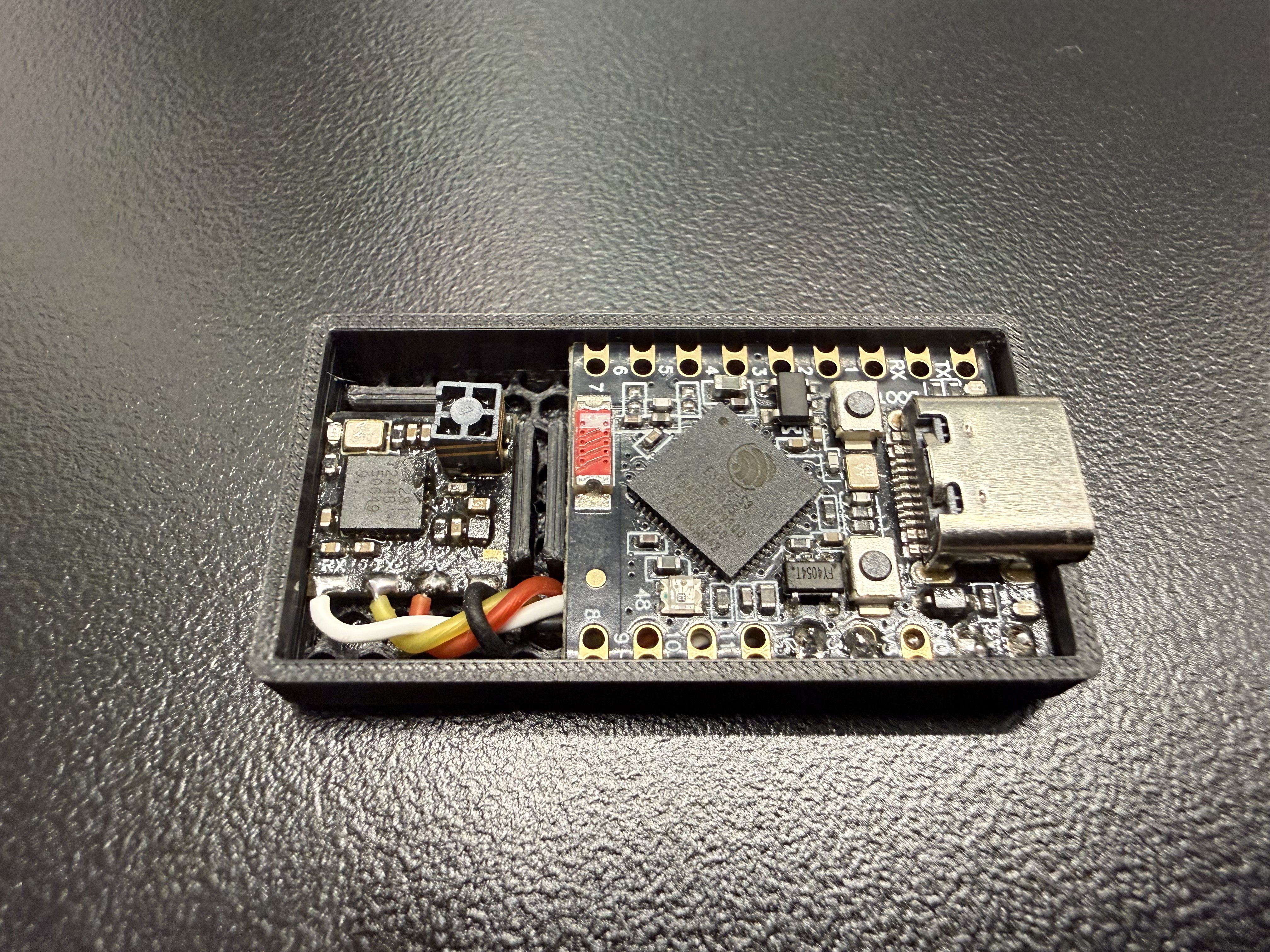 3D-printed enclosure open, showing ESP32-S3 and ELRS receiver mounted inside